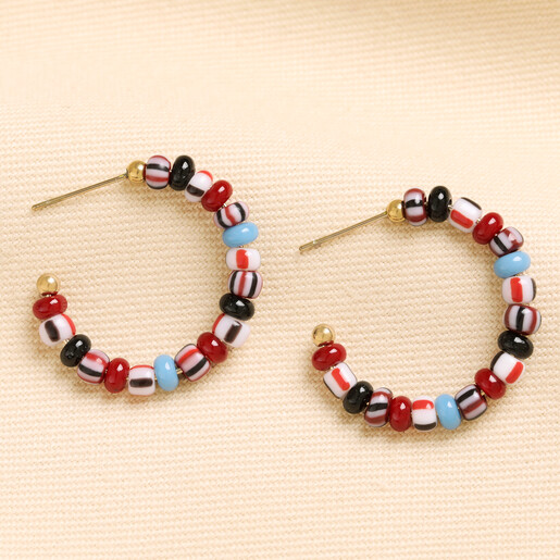 Pair of gold hoop earrings with colourful red, blue and striped glass beads