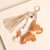 Tan faux leather dog bag charm with tassel and colourful semi precious beads