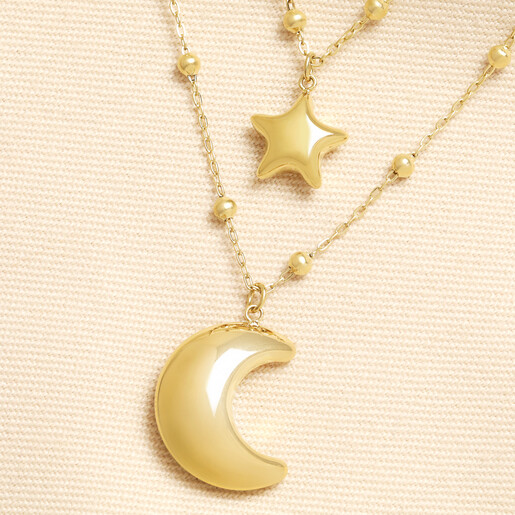 Close up of gold celestial double layer necklace with star and crescent moon pendants