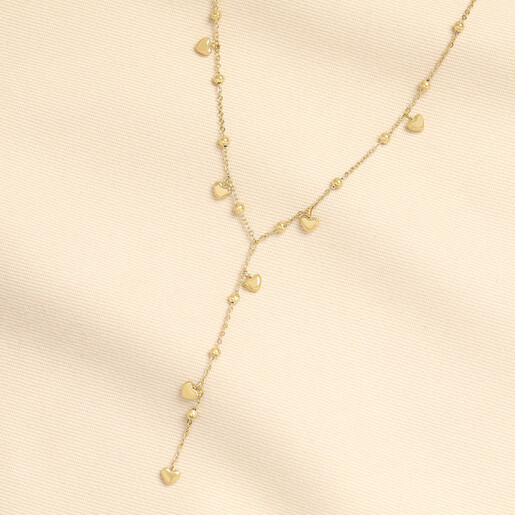Gold stainless steel Y-drop lariat necklace with dainty heart charms and bead details.