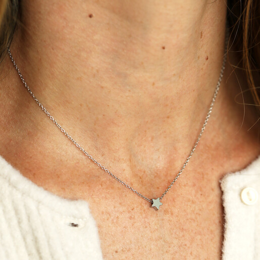 tiny star pendant necklace on model