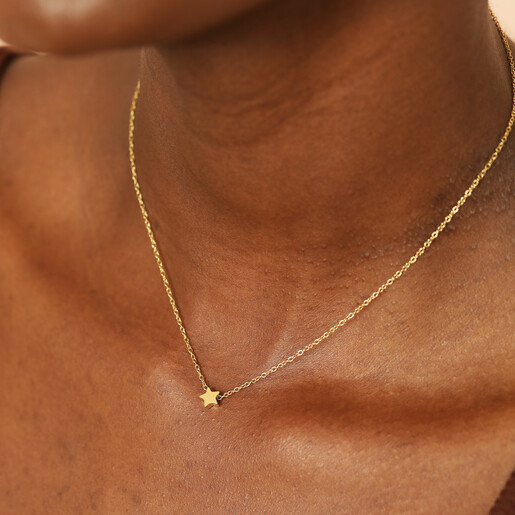 tiny star charm necklace on model