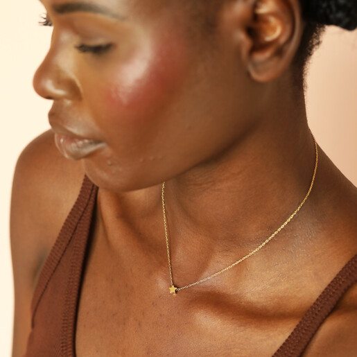 waterproof charm necklace in gold on model