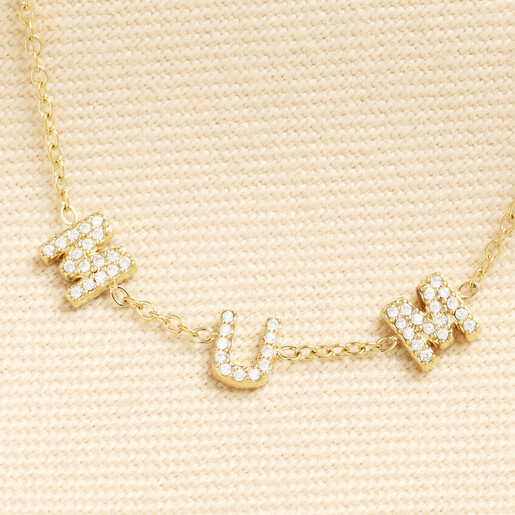 Close up view of crystal MUM letter charms on gold chain.