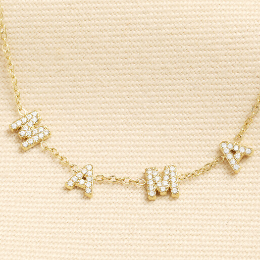 Close up of crystal encrusted MAMA charms on gold chain necklace
