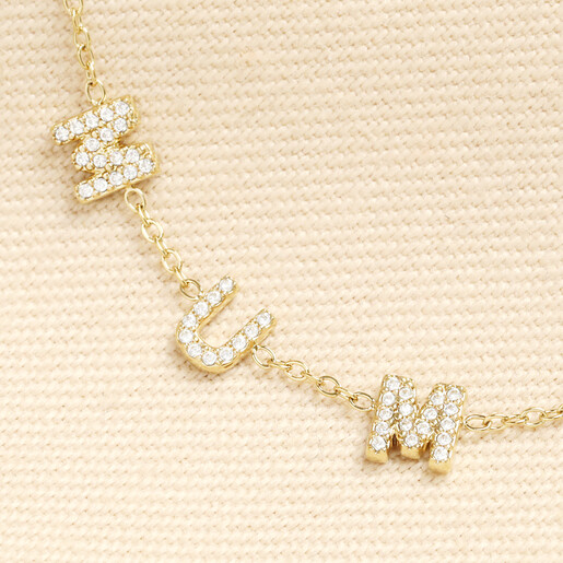Close up of crystal pave MUMMY letters on a gold stainless steel chain.