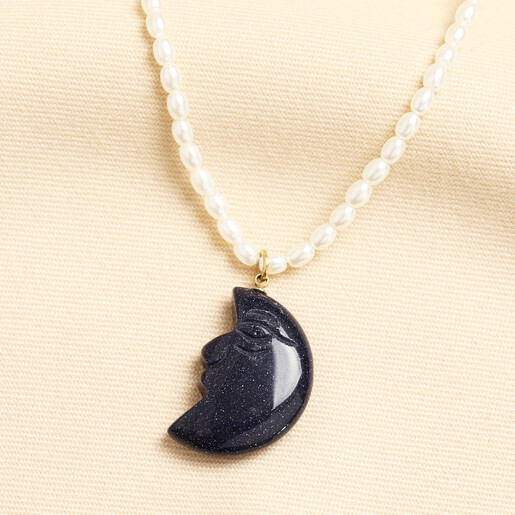 Delicate white pearl necklace with glittering blue crescent moon pendant in gold