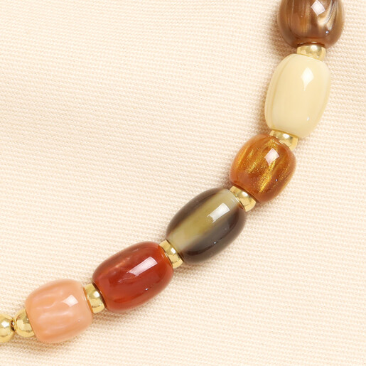 Detailed view of colourful autumn resin beads and polished gold spacers