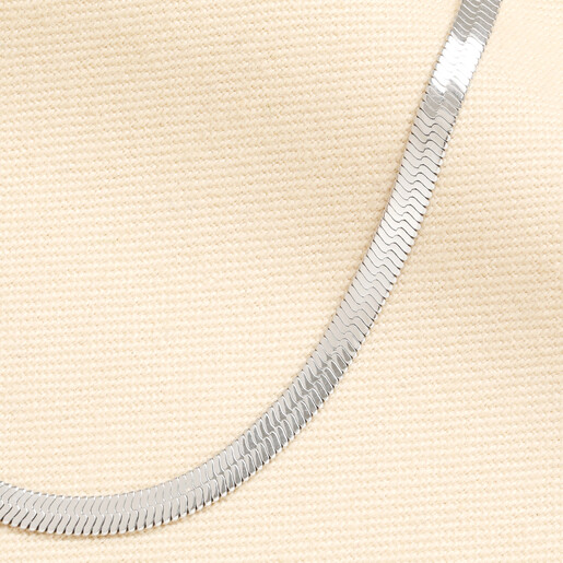 Close-up of polished silver links on a stainless steel herringbone chain necklace