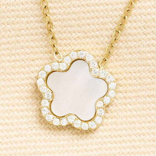 Close up of gold stainless steel necklace with pearl and cubic zirconia flower pendant