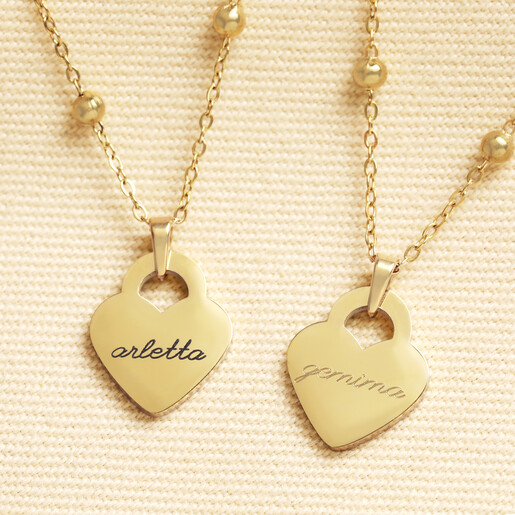 Two gold heart charm necklaces engraved with script names arletta and gemma