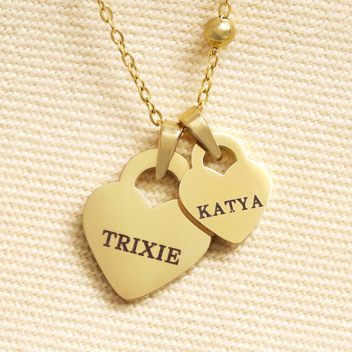 Close up of personalised gold double heart charm necklace engraved with names