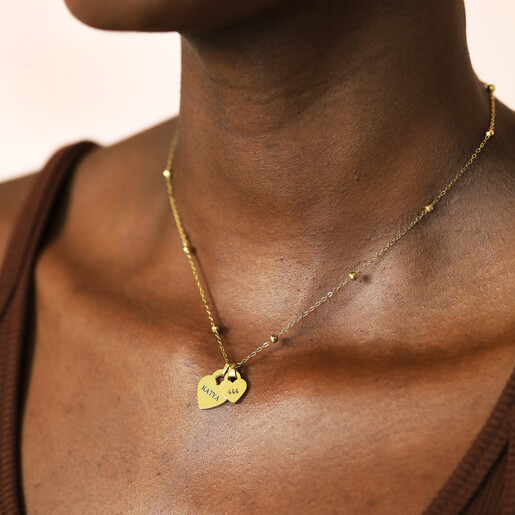 Model wearing gold personalised heart charm satellite chain necklace