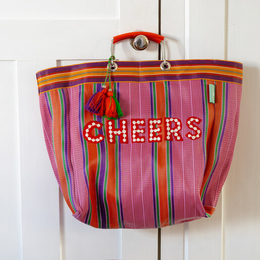 Talking Tables recycled plastic Cheers tote bag with colourful stripes hanging on a door knob