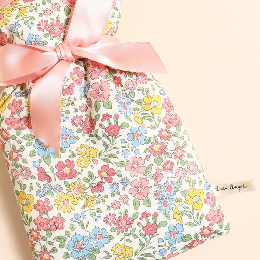 Close up of colourful Annabella floral Liberty print fabric and pink ribbon bow