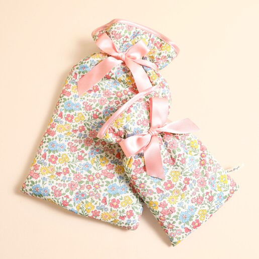 Large and small Annabella floral Liberty hot water bottles shown together