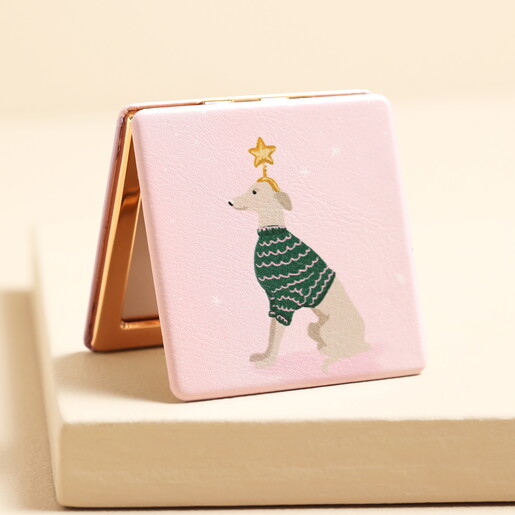 Square pink compact mirror with an illustrated dog wearing a green knit jumper