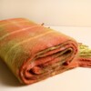 Close up view of the soft brushed texture on a folded tartan winter scarf