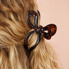 close up of bow-shaped hair clip on model