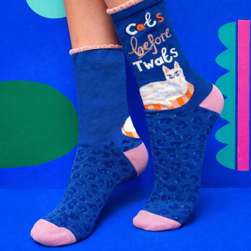 Model wearing blue novelty cat socks with pink frill cuffs and leopard print