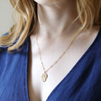 Lisa Angel Ladies' Gold Textured Hamsa Hand Necklace on Model