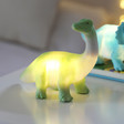 House of Disaster Mini Diplodocus LED Night Light on Bedside Table