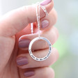 Model Holds Personalised Silver Halo Necklace with Model