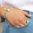 Ladies' Turquoise Beaded Stretch Ring with Shell Charm on Model