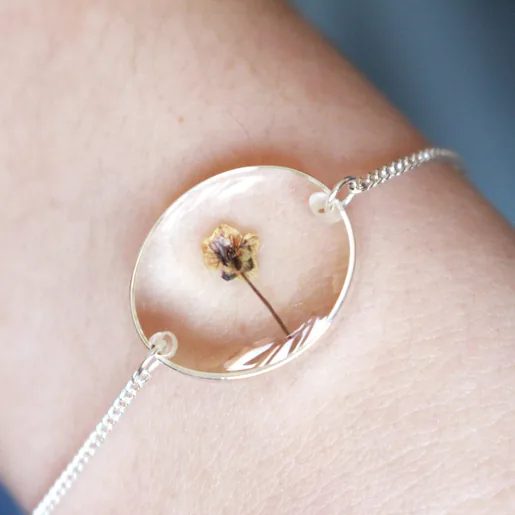Close Up of Pressed Birth Flower Charm Bracelet in Silver