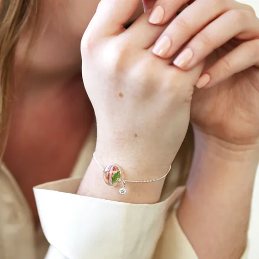 Model Wearing Lisa Angel Ladies' Silver Pressed Birth Flower Charm Bracelet with Birthstone Charm