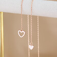 Clasp open on Lisa Angel Mismatched Heart Lariat necklace in Rose Gold