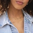Model Wearing Lisa Angel Dinosaur Charm Necklace in Gold