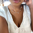 Model Wearing Lisa Angel Ladies' Dinosaur Charm Necklace in Silver
