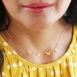 Close Up of Mama Charm Necklace in Gold on Model