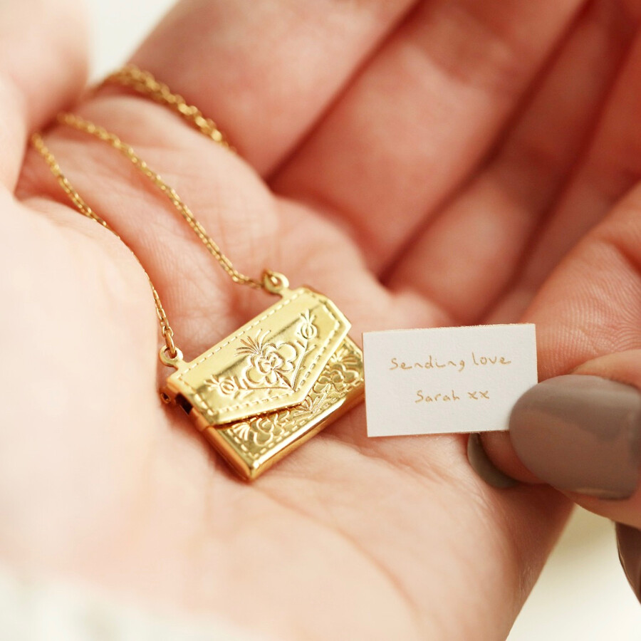 Personalised Envelope Locket Necklace with Hidden Charm Held in Model's Hand