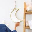 Gold framed moon wall mirror with jute strap from Lisa Angel