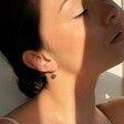 Model Wearing Lisa Angle Mini Sterling Silver Heart Charm Huggie Hoop Earrings