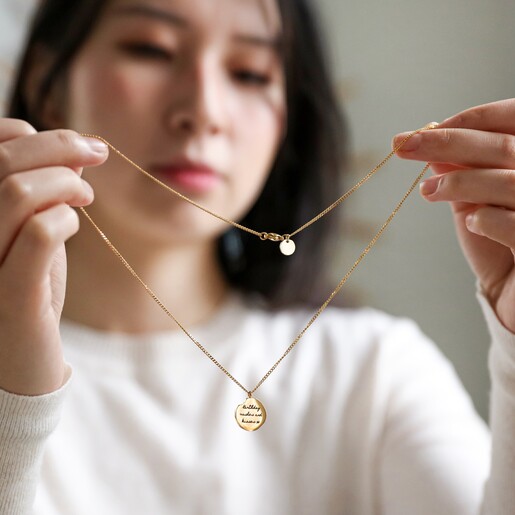 Model Holding Up Personalised Gold Stainless Steel Zodiac Pendant Necklace