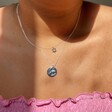 Model wears Lisa Angel Ladies' Personalised Engraved Birth Flower Disc Necklace