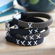 Men's Personalised Family Kiss Woven Cord Bracelets Stacked on Wooden Surface