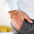 Model Shot of Slim Rainbow Braided Leather Bracelet with his hand in his pocked