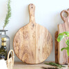 Round Olive Wood Pizza Board in Kitchen Against a White Wall