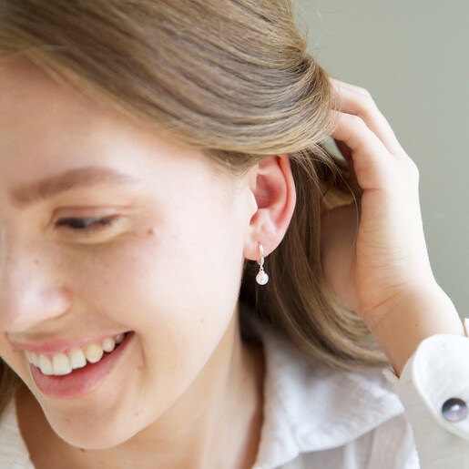 Model Wears Lisa Angel Glass Pearl Huggie Hoop Earrings in Silver