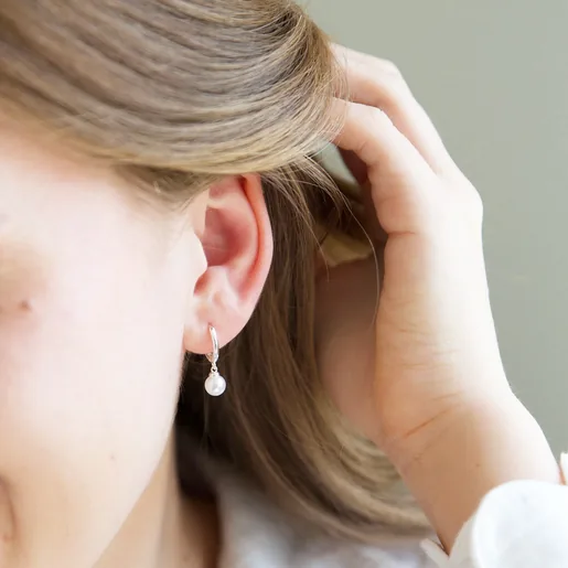 Lisa Angel Glass Pearl Huggie Hoop Earrings in Silver on Model