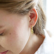 Lisa Angel Wing Charm Huggie Hoop Earrings in Gold on Model