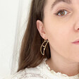 Lisa Angel Sleeping Crescent Moon Face Drop Earrings in Gold on Model