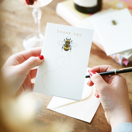 Model holding one card from Set of 10 Bee Design Thank You Cards