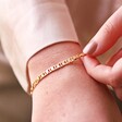 Close Up of Model Wearing Flat Figaro Chain Bracelet in Gold