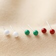 Ball Stud Earrings in green, red and white on fabric background