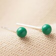 Green Ball Stud Earrings in Gold on fabric background
